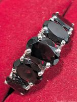 Top view showing five oval garnets in prong settings