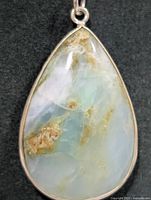 Front view pear-shaped aquaprase pendant in silver bezel