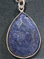 Front view of teardrop lapis lazuli pendant in silver bezel