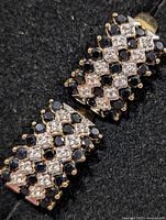 Close-up of one earring showing sapphire and CZ checkerboard pattern