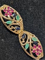 Front view of one earring showing gemstone arrangement