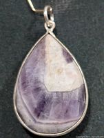 Front view of teardrop chevron amethyst pendant in silver bezel