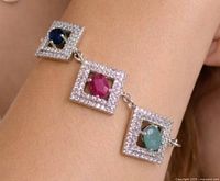 Full view of bracelet on wrist showing three gemstone links