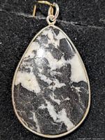 Front view of teardrop zebra jasper pendant in silver bezel