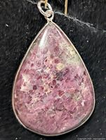 Front view of thulite pendant in silver setting