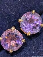 Front view showing both amethyst studs and prong settings