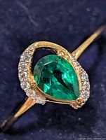 Top view of ring showing pear-cut chrome diopside and accent stones