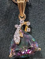 Front view of pendant showing mystic topaz, prongs and accent stones