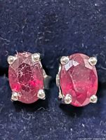 front view of both ruby stud earrings showing stones and prongs