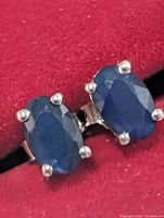 Front view of both oval sapphire studs in silver settings