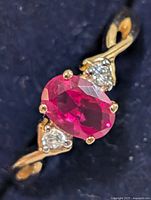 Top view of ring showing oval synthetic ruby and accent stones