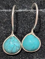 front view of both earrings showing turquoise cabochons and silver hooks