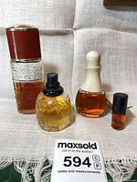 Full group shot of all four perfume bottles with MaxSold lot number