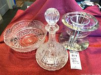 Overall view of cut crystal bowl, cut crystal decanter with stopper, Bodum glass bowl in stainless stand