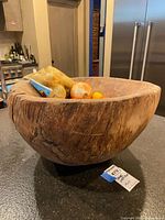 Angled view of large wooden dough bowl on countertop