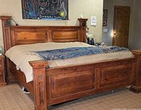Full view of assembled king bed frame showing headboard, footboard, posts and finish