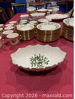 Multiple pieces of Lenox Holiday serveware on table including scalloped bowl