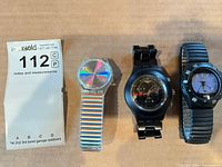 Overview of the three Swatch watches in the lot