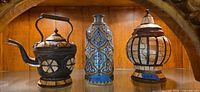 Wide shot of all three decorative vessels on shelf
