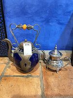 Both teapots side by side showing overall design, color and size comparison