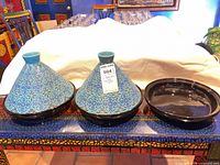 Full set showing two tagines and extra plate on table
