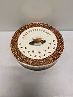 Closed round tin labeled 6 PCE Espresso Set