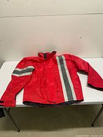 Full view of front of red Corazzo jacket showing reflective stripes and general condition