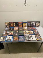 All DVD & Blu-ray cases laid out on table, full lot view