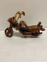 Full left-side view of wooden motorcycle showing overall design and scale