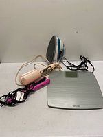 Group view of iron, scale, two hair tools