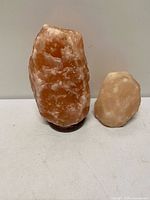 Large and small Himalayan salt lamps side by side
