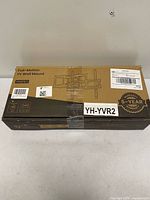 Sealed box labelled Full-Motion TV Wall Mount with model and warranty
