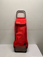 Front view of red Rolser folding shopping trolley