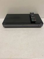 Front and top view of Sony BDP-S560 player with remote on top