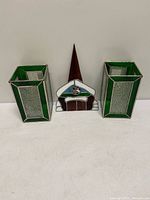 Front view of the church panel flanked by two stained glass candle holders