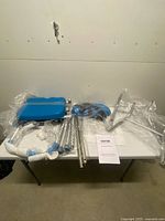 All components of VEVOR tub transfer bench kit on table, wrapped in plastic