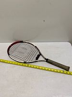 Full view of Wilson Double Beam racket with tape measure showing length