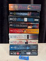 Stack of nine Lisa Jackson paperback books showing titles on spines