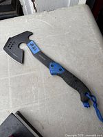 Full view of axe on table showing overall form