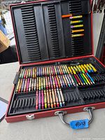 Entire open case showing crayons, pencils and small Crayola sticks
