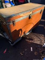 Front and top view of cedar-lined trunk showing latches, metal edges, color, wear