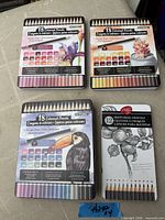 four closed tins showing counts and graphics