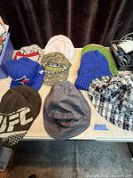 All eight hats laid out on table