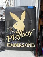Front view of rectangular Playboy wall art clock showing bunny logo, clock face and lettering