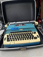 Celebrity 12 typewriter inside open carry case showing color scheme and keyboard