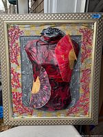 Front view of framed mixed-media papier mâché artwork with torso, fans, cherry blossoms