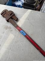 Full view of 24" E.T.E. pipe wrench showing red handle and overall wear