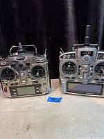 Front view of both transmitters showing controls and screens