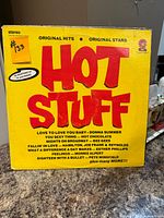 Front cover of Hot Stuff compilation LP showing title and track highlights