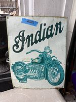 Front view of the Indian Motorcycle metal sign showing logo, motorcycle illustration, mounting holes and surface wear
